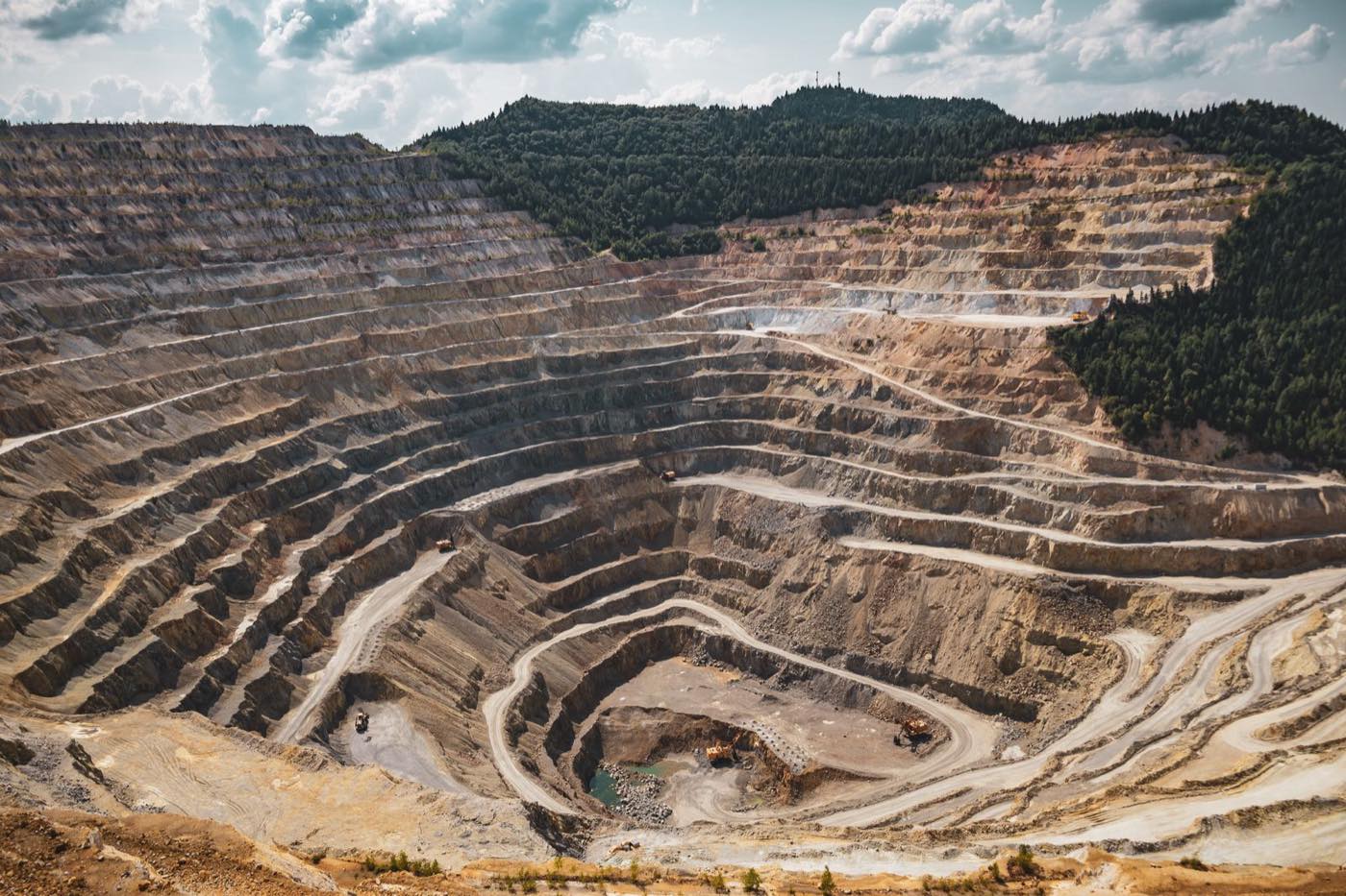 Terraced open-pit mine representing critical-minerals resource valuation