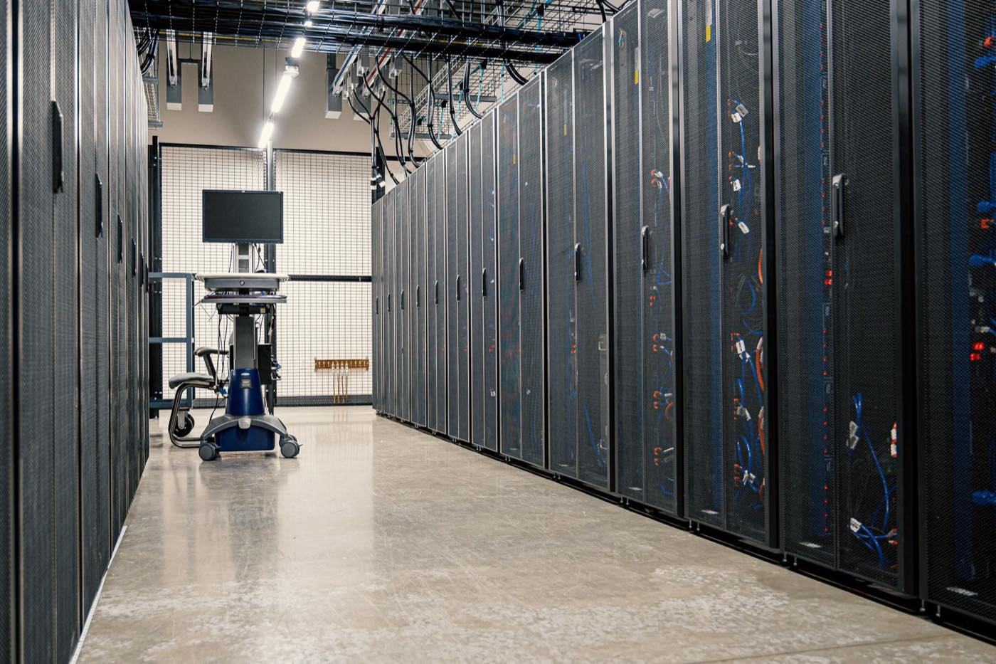 Rows of server racks in a secure datacentre representing sovereign AI compute capacity