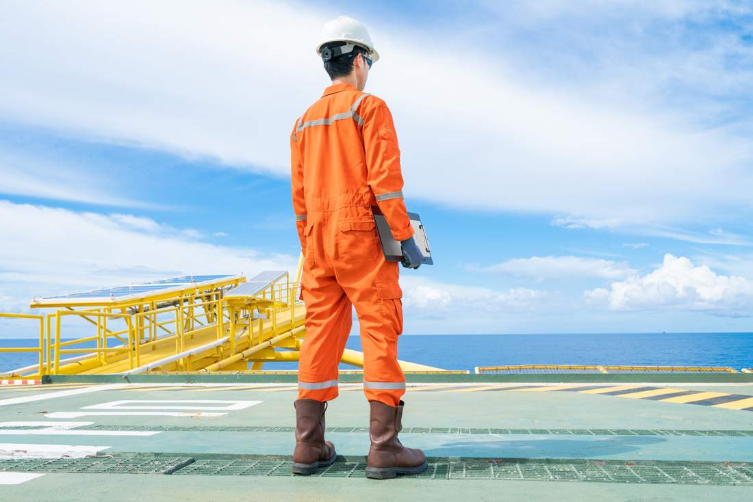 Offshore crew member on a platform helideck